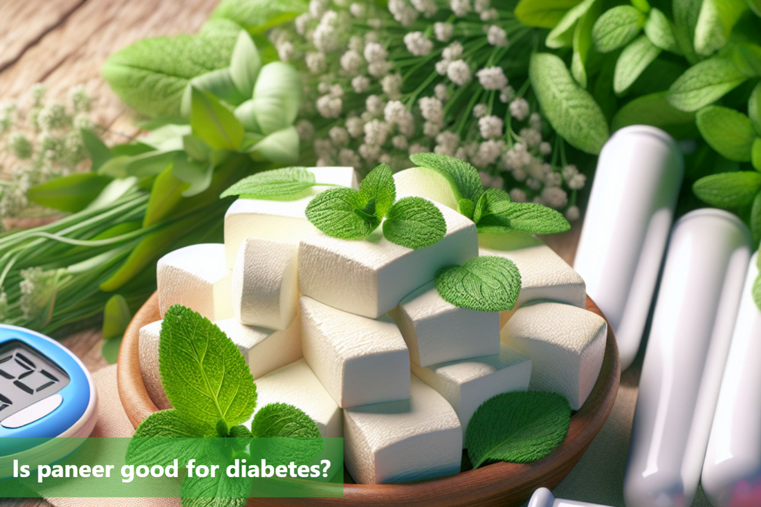 An image of paneer cubes on a wooden table. The paneer is garnished with mint leaves. There is a blood sugar meter and some flowers in the background.