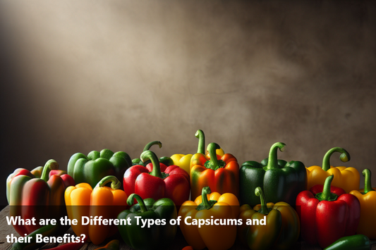 A variety of colorful capsicums on a wooden table.