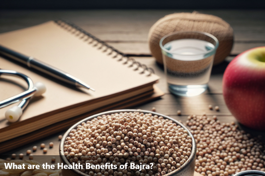 A bowl of bajra millet with a stethoscope, an apple, a glass of water, a notebook, and a pen on a wooden table.