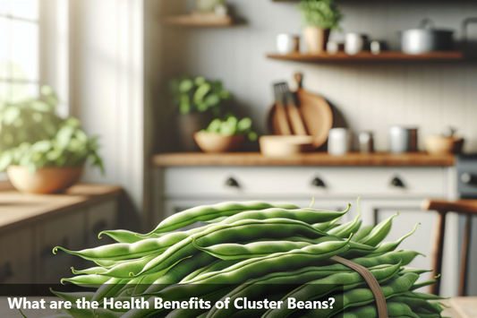 A close-up image of a bunch of fresh, green cluster beans on a wooden table in a bright kitchen.