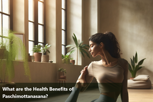 A woman doing Paschimottanasana, or Seated Forward Bend, in a yoga studio.