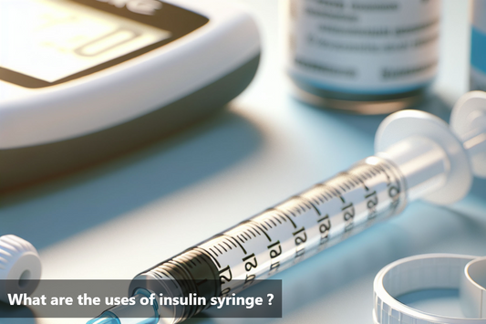 An insulin syringe lies on a table next to a blood glucose meter and a vial of insulin.