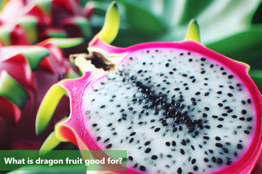A close-up image of a dragon fruit cut in half, showing its vibrant pink flesh and black seeds.