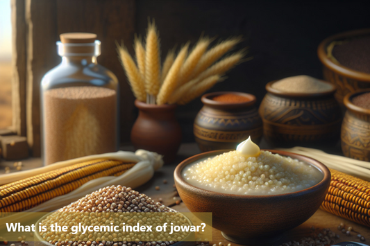 A bowl of jowar grains and a bowl of jowar porridge, with a glass jar and clay pots in the background.